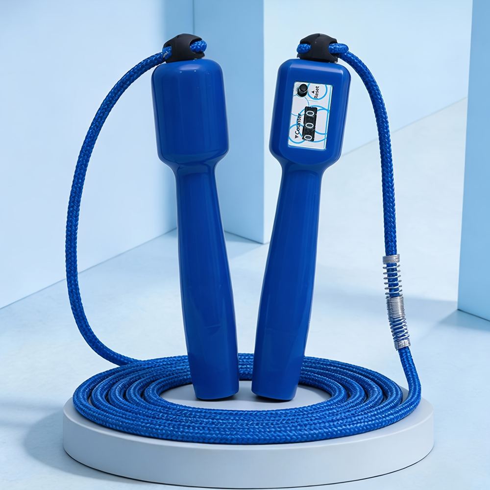 A mechanical counting jump rope with adjustable 270cm cable coiled on a gym floor