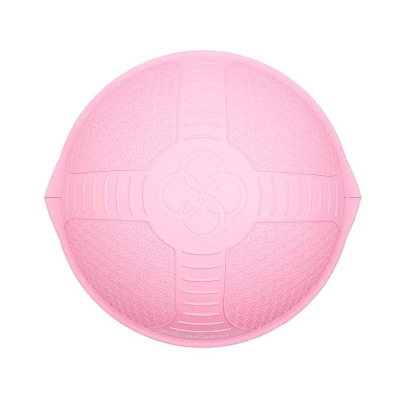 A pink Bosu balance trainer ball used for core stability exercises