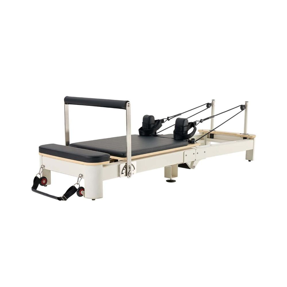 A foldable Pilates reformer in wood and aluminium for small home spaces